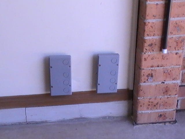 Termite bait stations on a garage wall in Camden